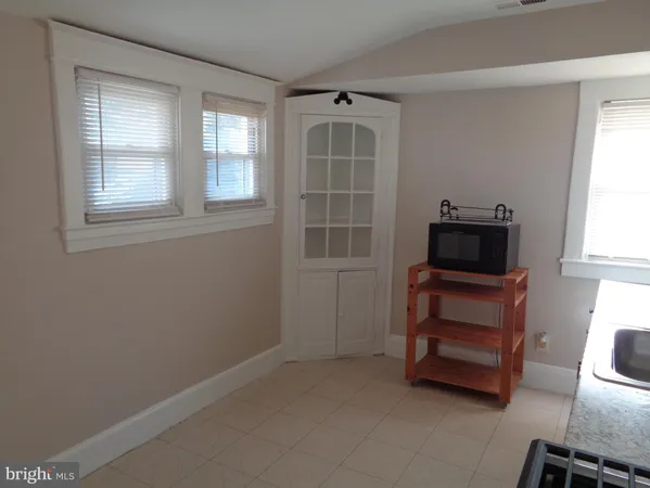 an empty room with furniture and windows