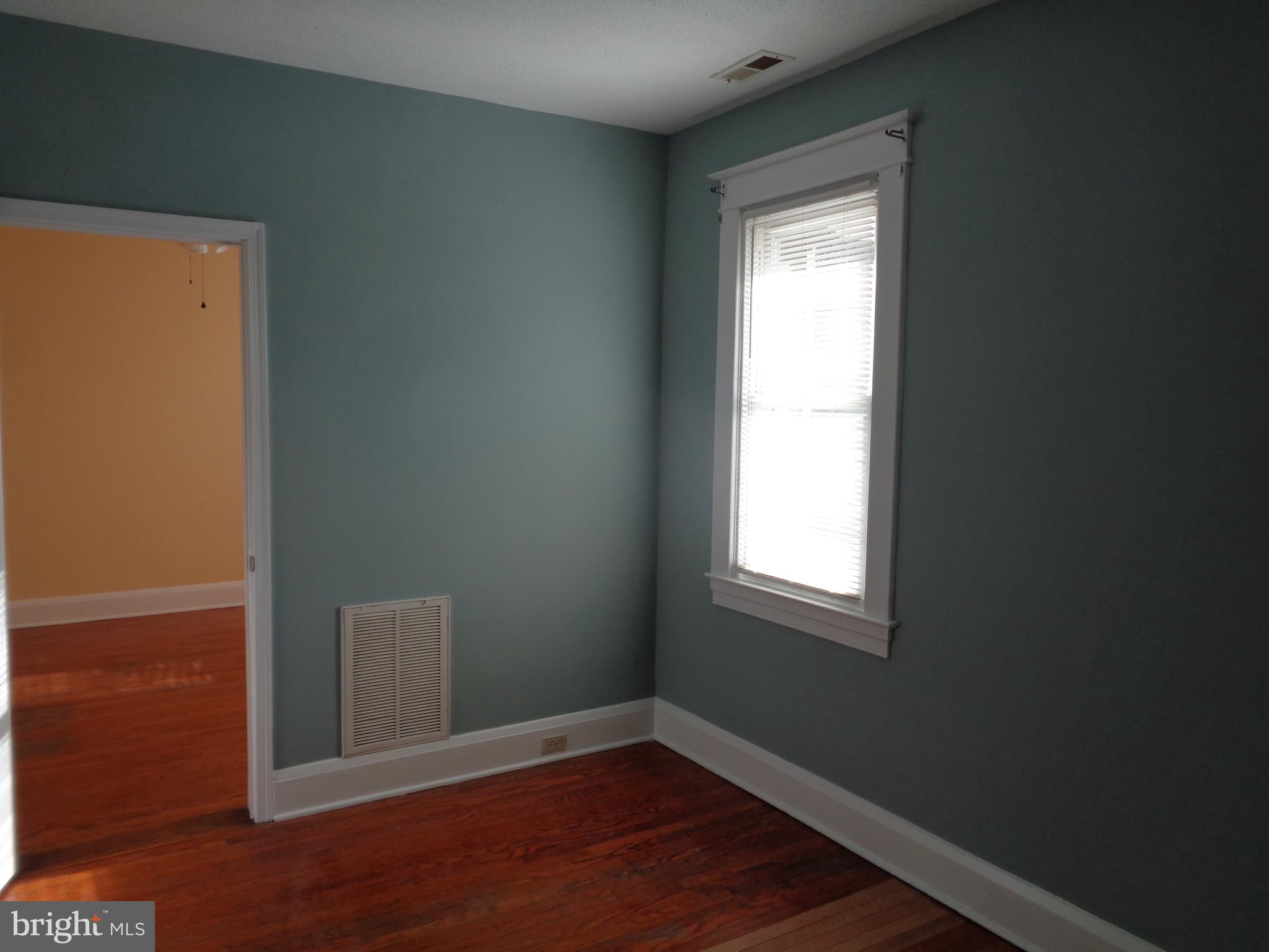 2800 Linwood Avenue, Unit C Baltimore, MD 21234 - Photo 10 of 18 an empty room with wooden floor and windows