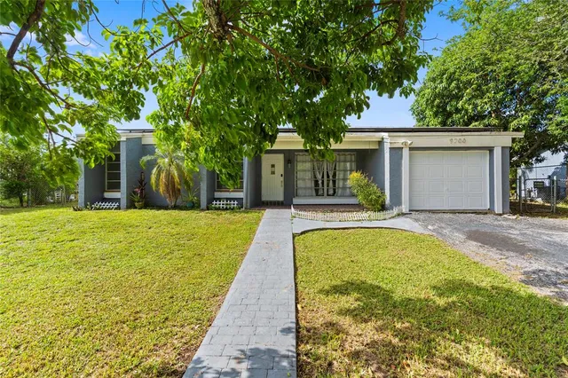 a house view with swimming pool in front of it