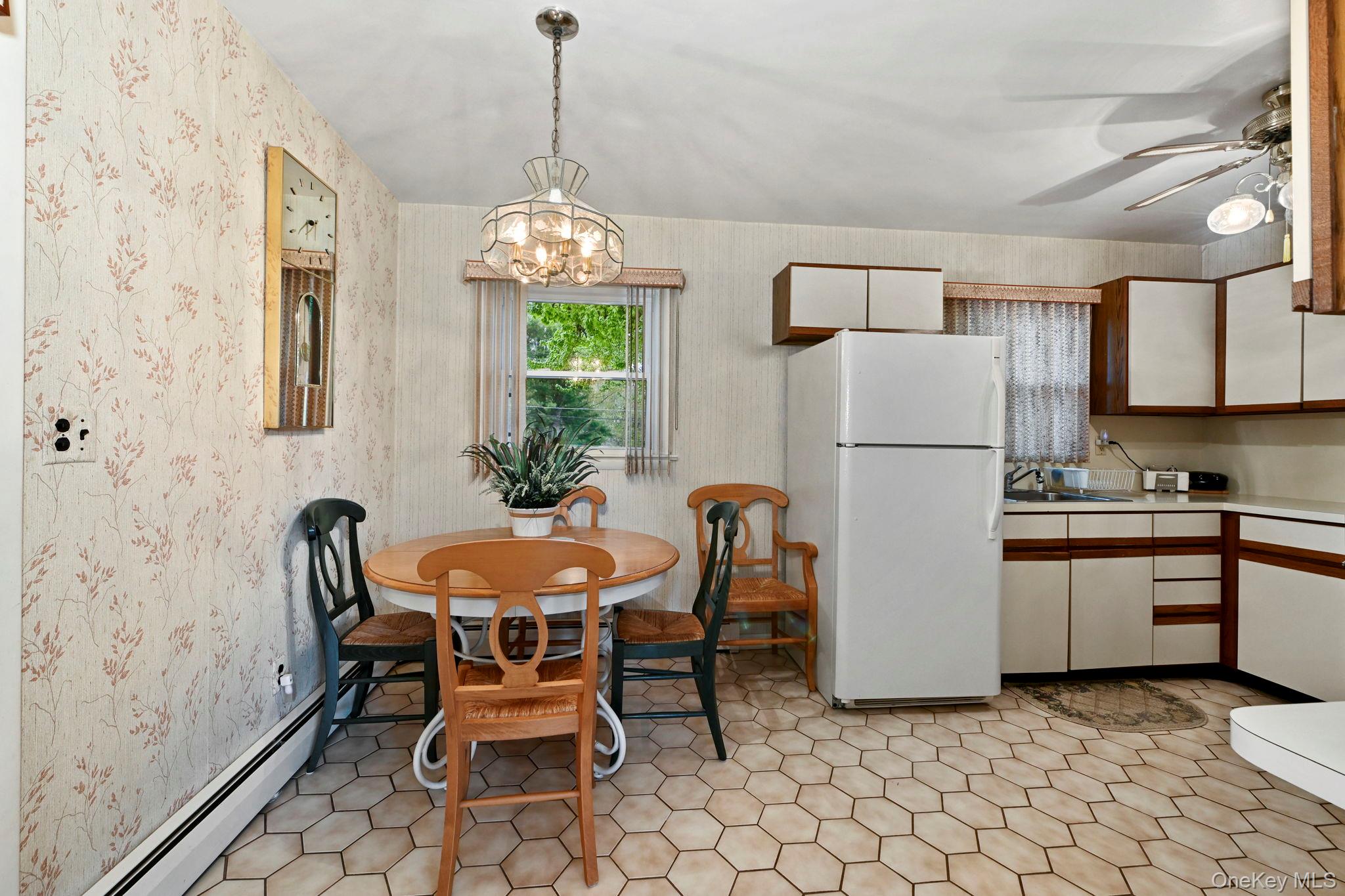 93 Fairmont Road Mahopac, NY 10541 - Photo 10 of 37 a kitchen with stainless steel appliances granite countertop a dining table chairs and a refrigerator