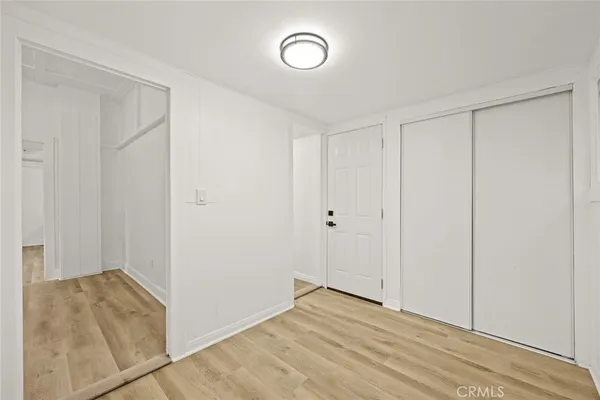 a view of a room with wooden floor and bathroom