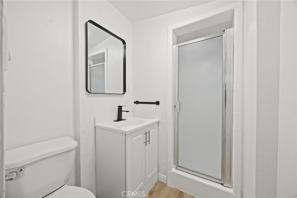 1412 Larch Street Alhambra, CA 91801 - Photo 15 of 28 a bathroom with a toilet a sink and mirror