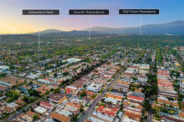 an aerial view of residential houses with city view