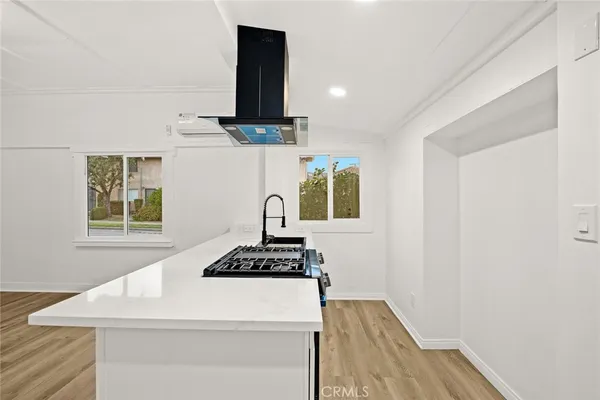 a kitchen with a stove and a window