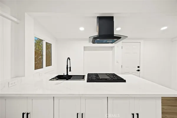 a cabinet with a stove and a refrigerator