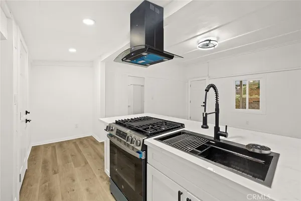 a kitchen view with a stove and a refrigerator