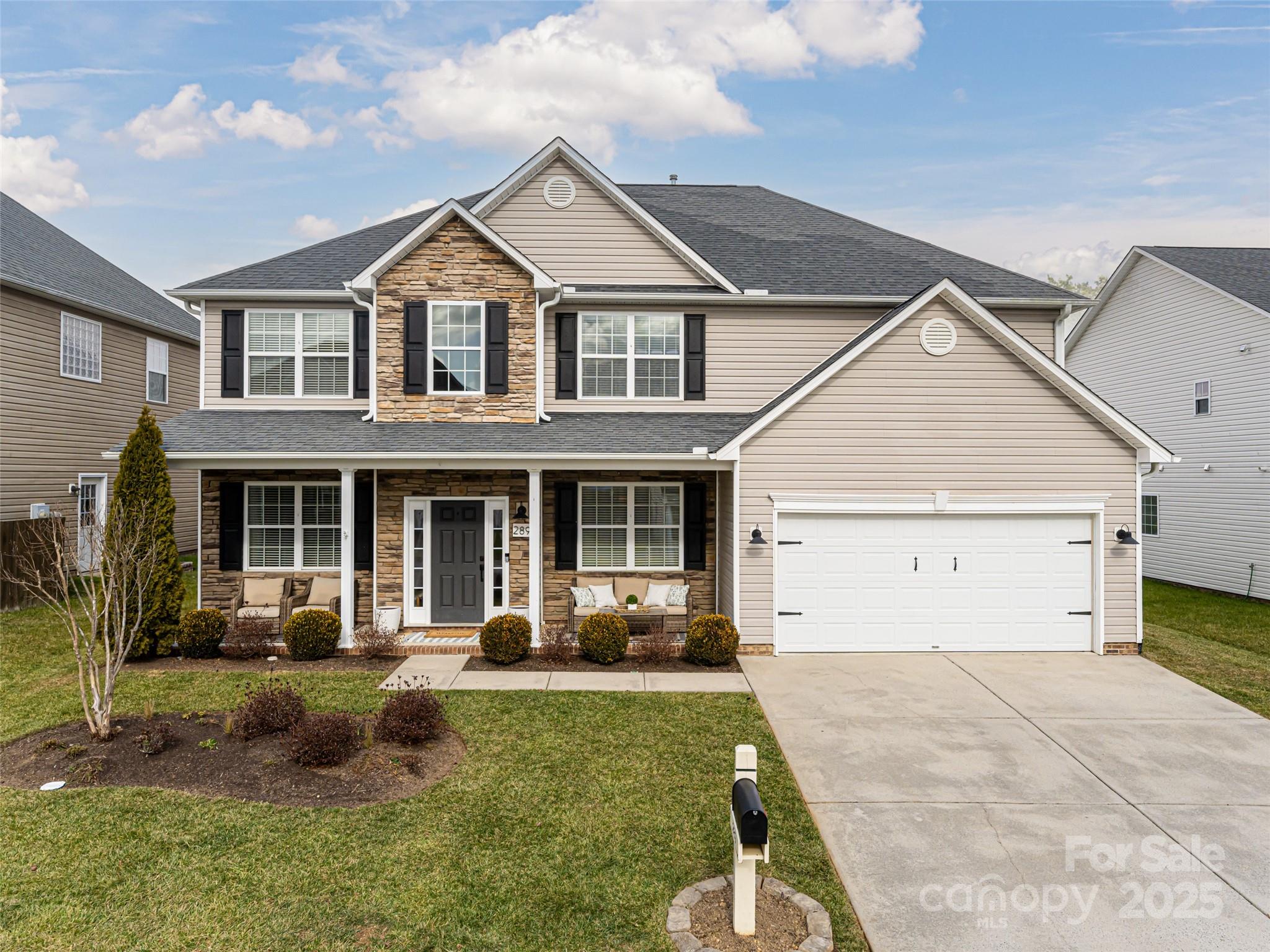 289 Roanoke Road Fletcher, NC 28732 - Photo 1 of 39 a front view of a house with a yard and potted plants