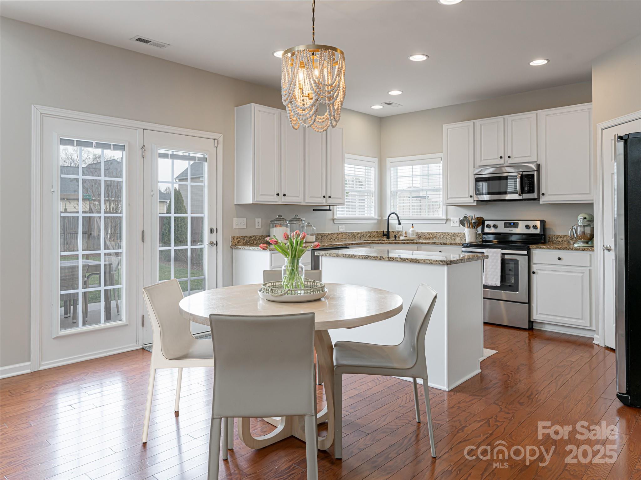 289 Roanoke Road Fletcher, NC 28732 - Photo 13 of 39 a kitchen with stainless steel appliances granite countertop a stove a sink a microwave a dining table and chairs
