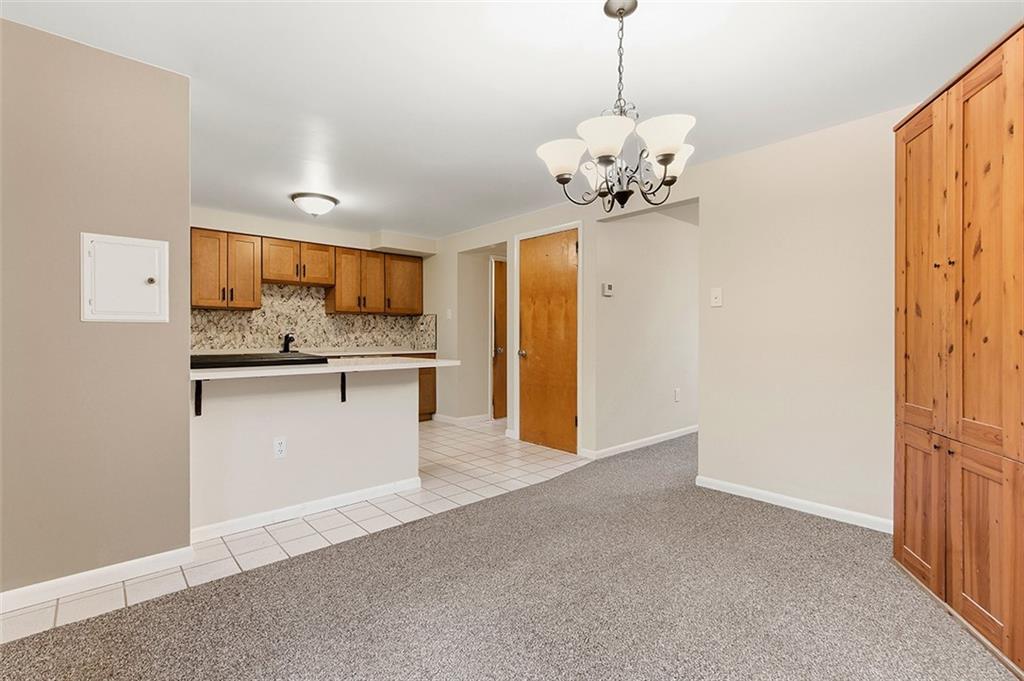 924 Old Hills Road McKeesport, PA 15135 - Photo 11 of 20 a view of a kitchen with a refrigerator a stove cabinets and a wooden floor