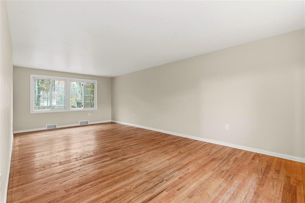924 Old Hills Road McKeesport, PA 15135 - Photo 14 of 20 an empty room with wooden floor and windows