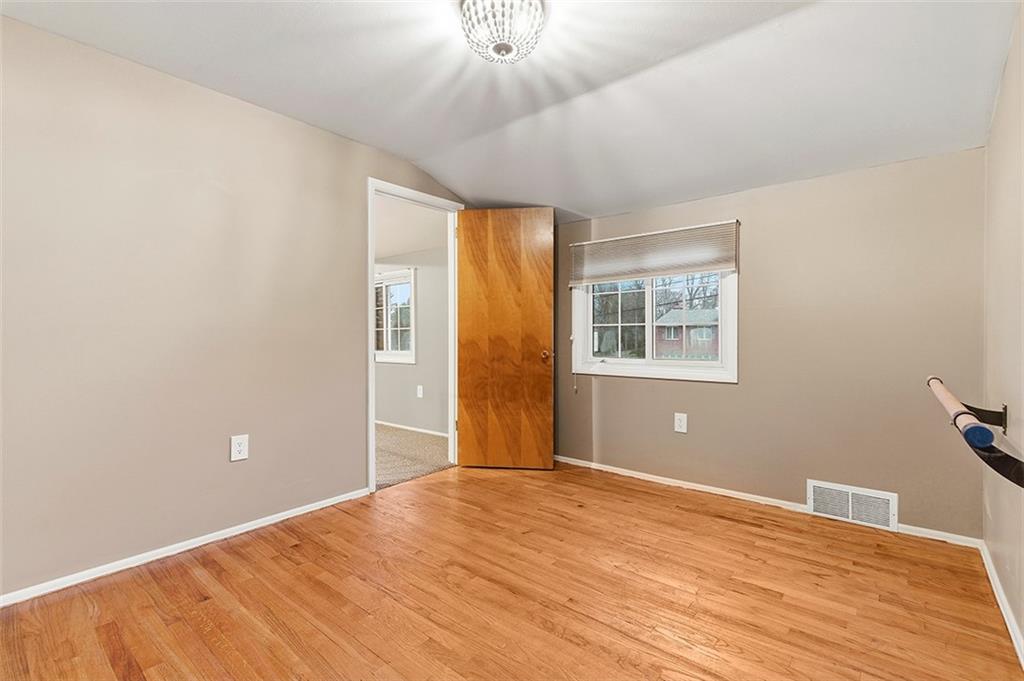 924 Old Hills Road McKeesport, PA 15135 - Photo 16 of 20 a view of an empty room with wooden floor and a window
