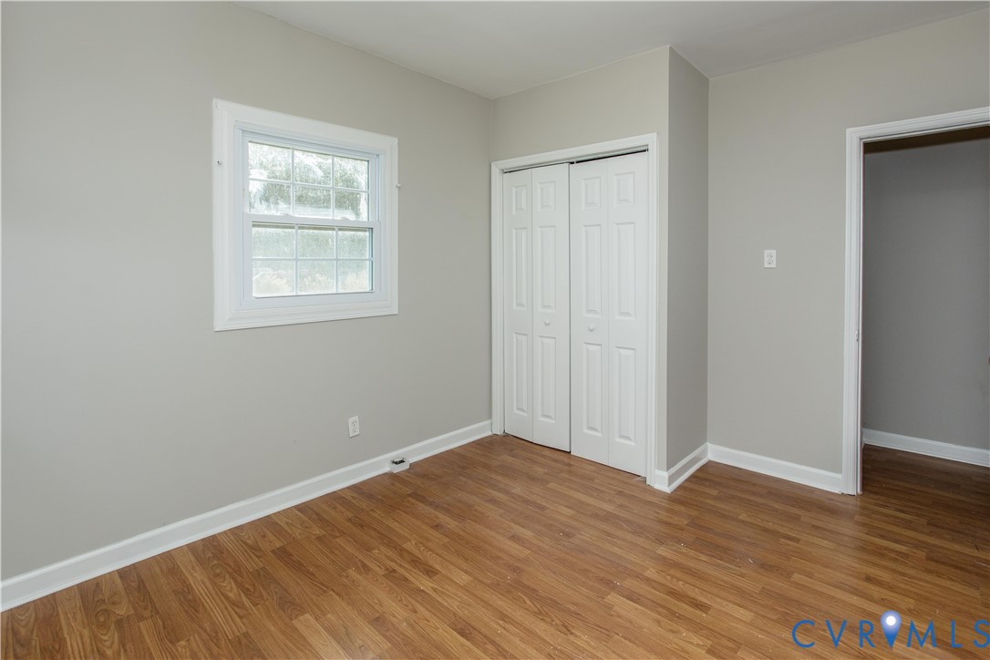 11512 Duncan Road Petersburg, VA 23805 - Photo 14 of 19 an empty room with wooden floor and windows