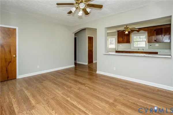 a view of a kitchen with wooden floor and a ceiling fan