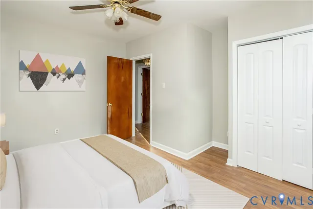 a bedroom with a bed and a painting on the wall