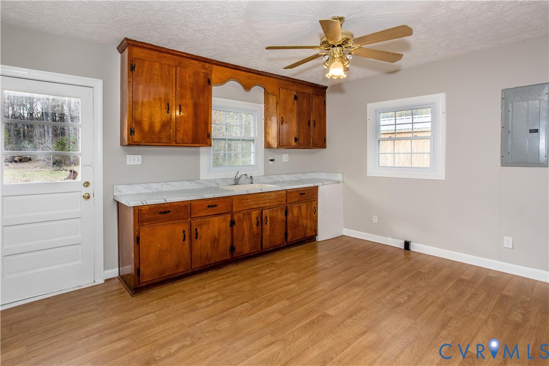 11512 Duncan Road Petersburg, VA 23805 - Photo 9 of 19 a kitchen with stainless steel appliances granite countertop a sink and cabinets with wooden floor