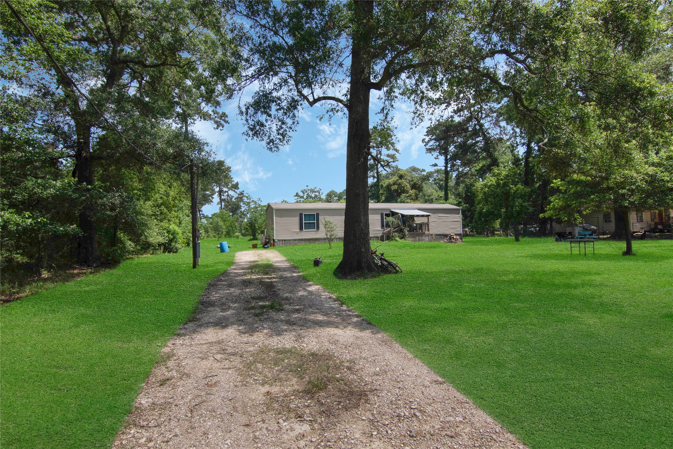 18093 Pickering Road Conroe, TX 77302 - Photo 17 of 29 a front view of a house with garden