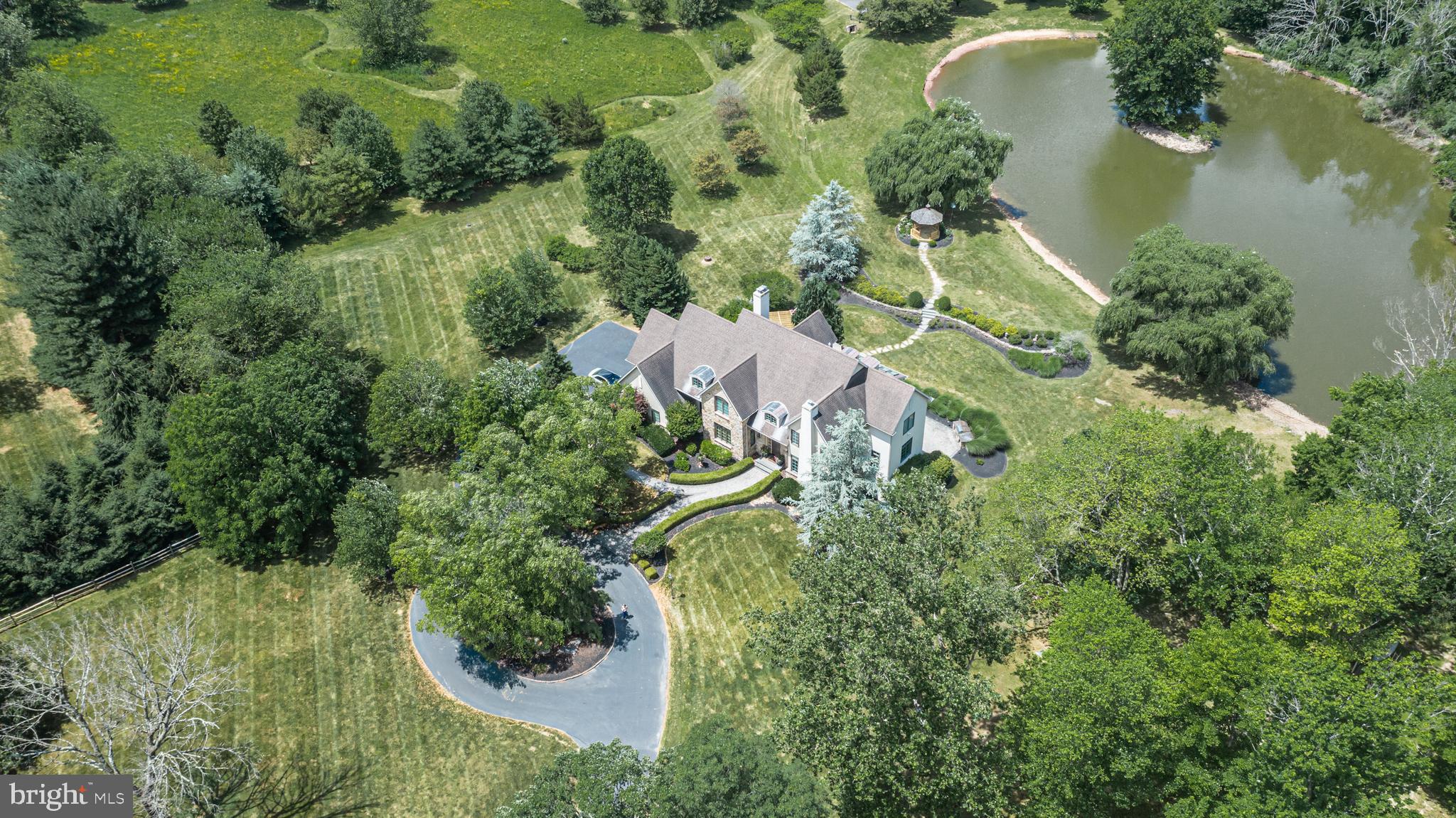 an aerial view of a house with a yard and lake view