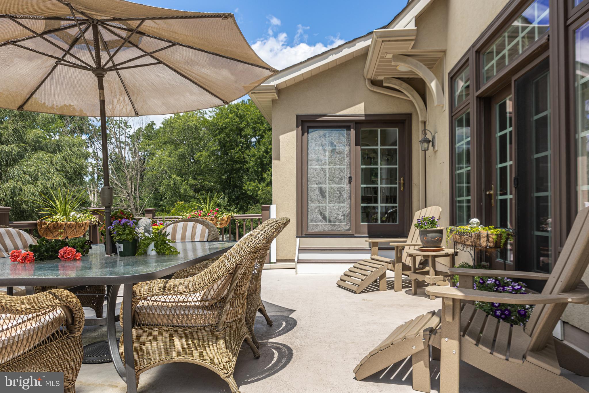 3380 Indian Springs Road Doylestown, PA 18902 - Photo 50 of 57 a view of a patio with couches table and chairs under an umbrella