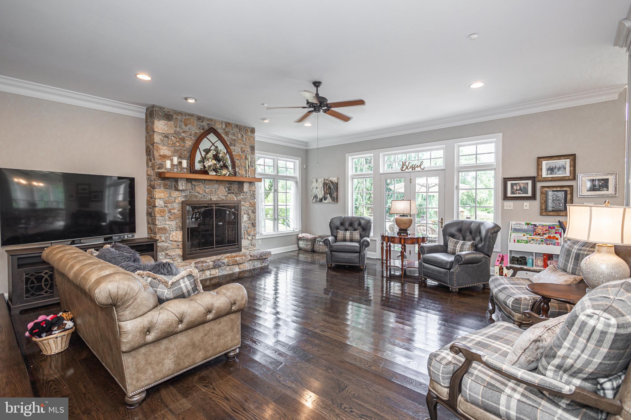 3380 Indian Springs Road Doylestown, PA 18902 - Photo 5 of 57 a living room with furniture a fireplace and a flat screen tv