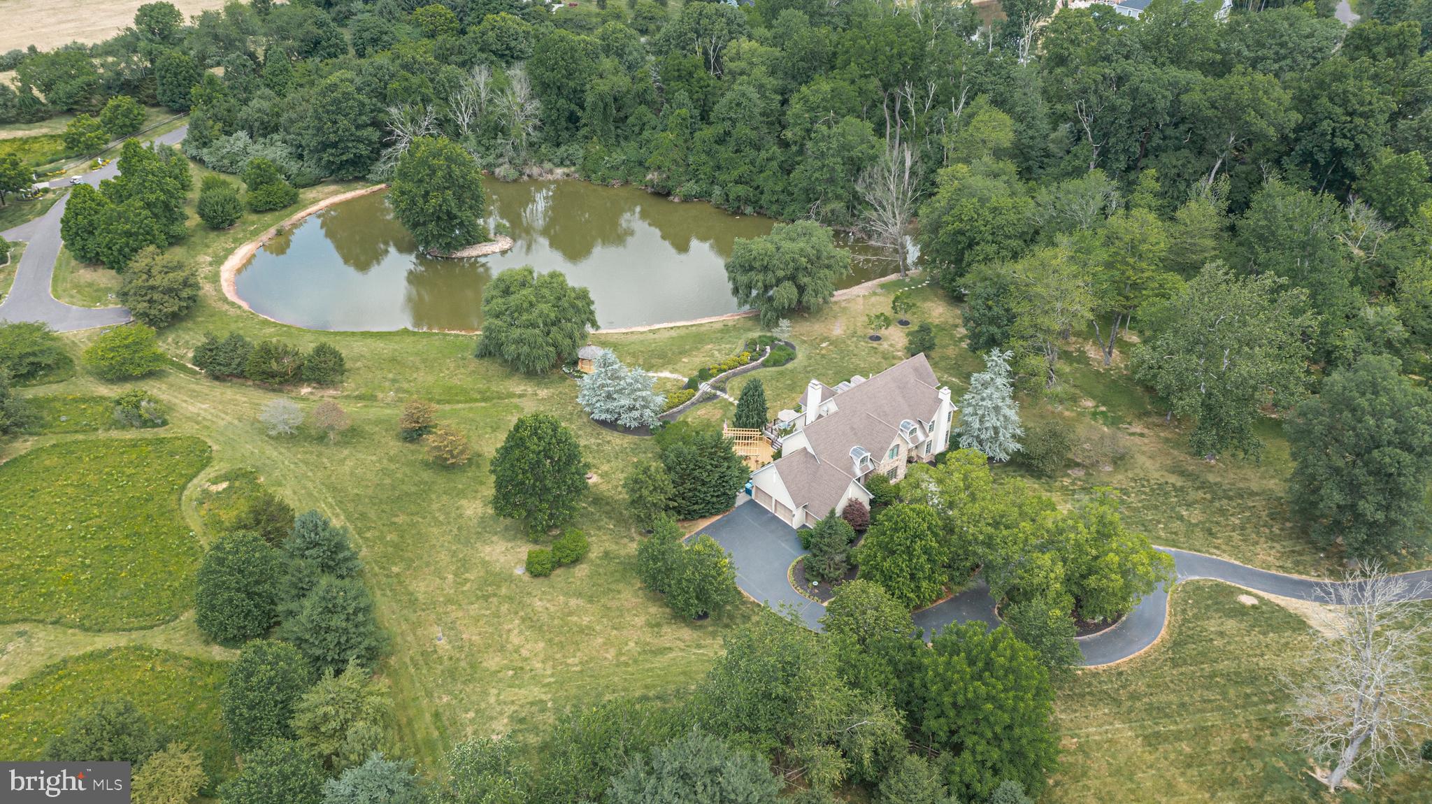 3380 Indian Springs Road Doylestown, PA 18902 - Photo 56 of 57 an aerial view of a house with a yard and large trees