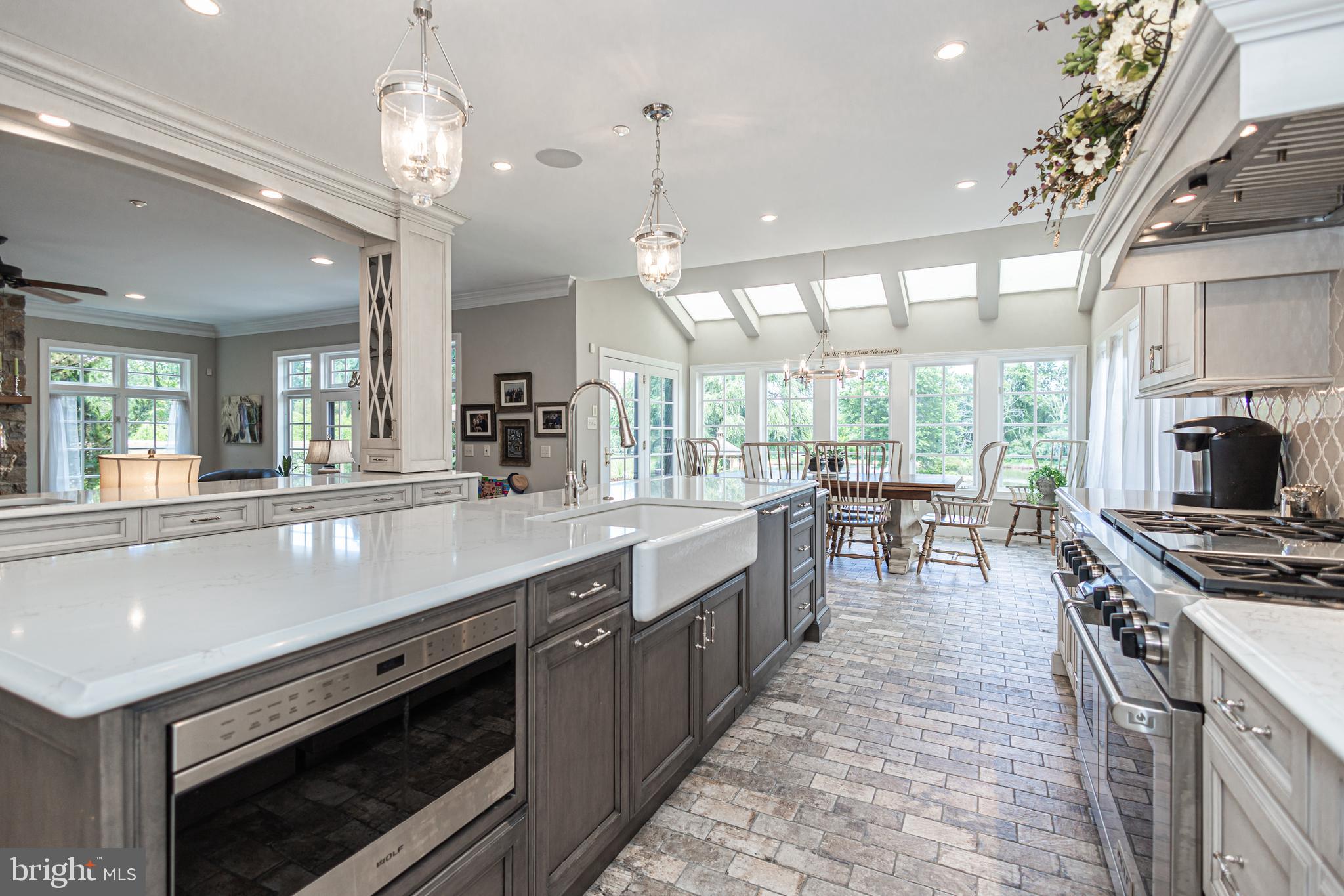 3380 Indian Springs Road Doylestown, PA 18902 - Photo 7 of 57 a large kitchen with stainless steel appliances a stove center island a flat screen tv and a large window