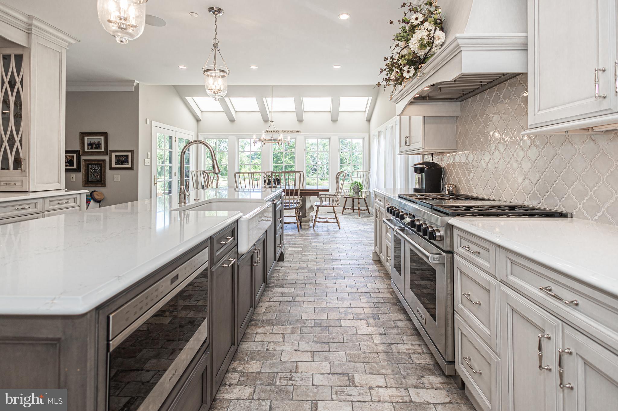 3380 Indian Springs Road Doylestown, PA 18902 - Photo 10 of 57 a open kitchen with kitchen island a stove a counter space a sink and cabinets