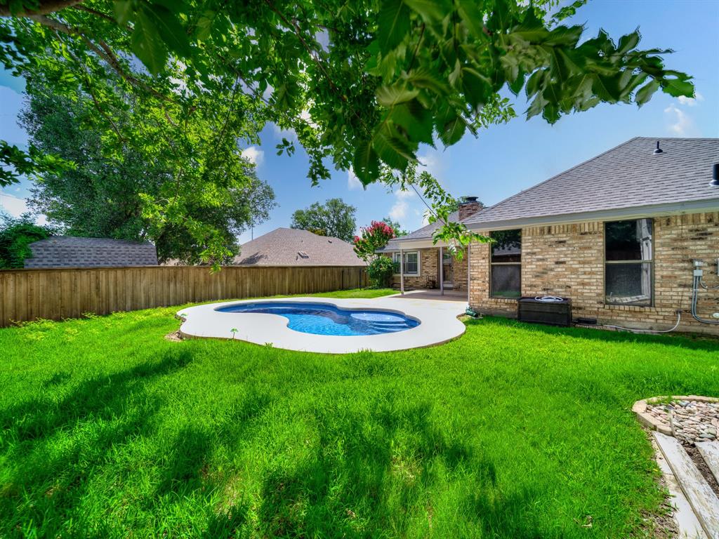 121 Northeast Brushy Mound Road Burleson, TX 76028 - Photo 35 of 35 a view of a house with pool and a yard