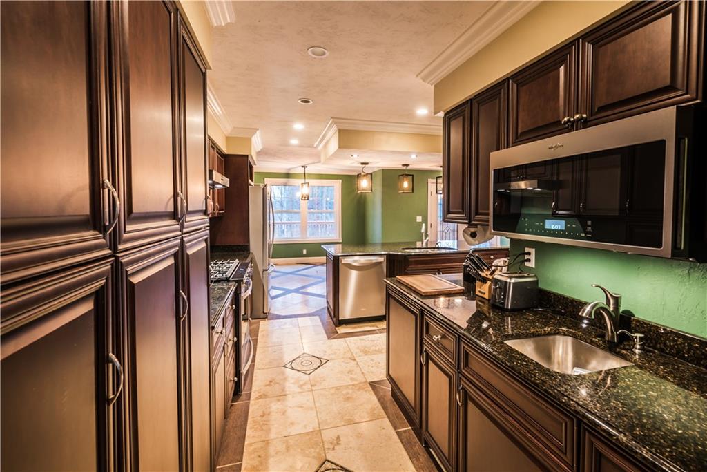 147 Heeter Road Knox, PA 16232 - Photo 8 of 40 a kitchen with stainless steel appliances granite countertop a sink a stove and a refrigerator