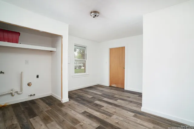 a view of an empty room with closet and a chandelier fan