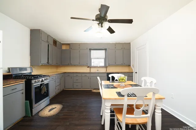 a kitchen with a stove a sink and a refrigerator