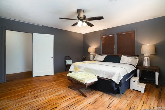 a bedroom with a bed and wooden floor