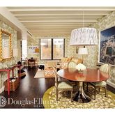 a dining room with furniture and a large window