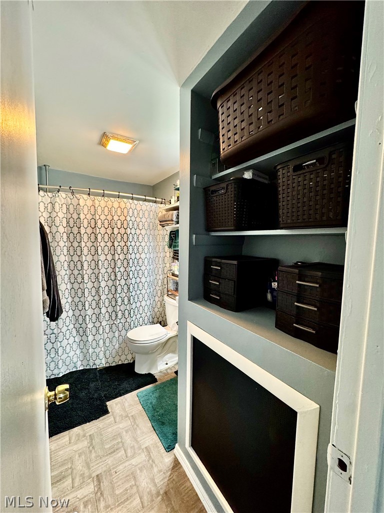 2852 Shelly Road Ravenna, OH 44266 - Photo 18 of 30 Bathroom with a shower with shower curtain and parquet flooring