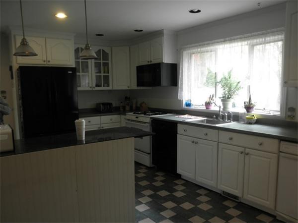 36 Jasper Street Saugus, MA 01906 - Photo 5 of 13 a kitchen with a sink appliances and cabinets