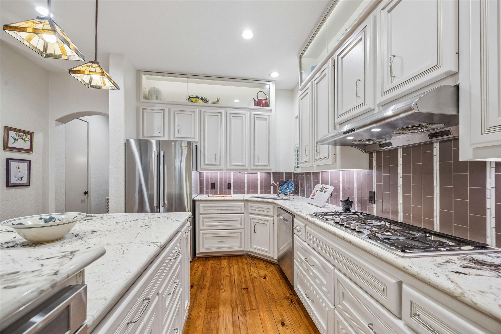 706 East 12th Street Houston, TX 77008 - Photo 17 of 34 a kitchen with a stove and white cabinets