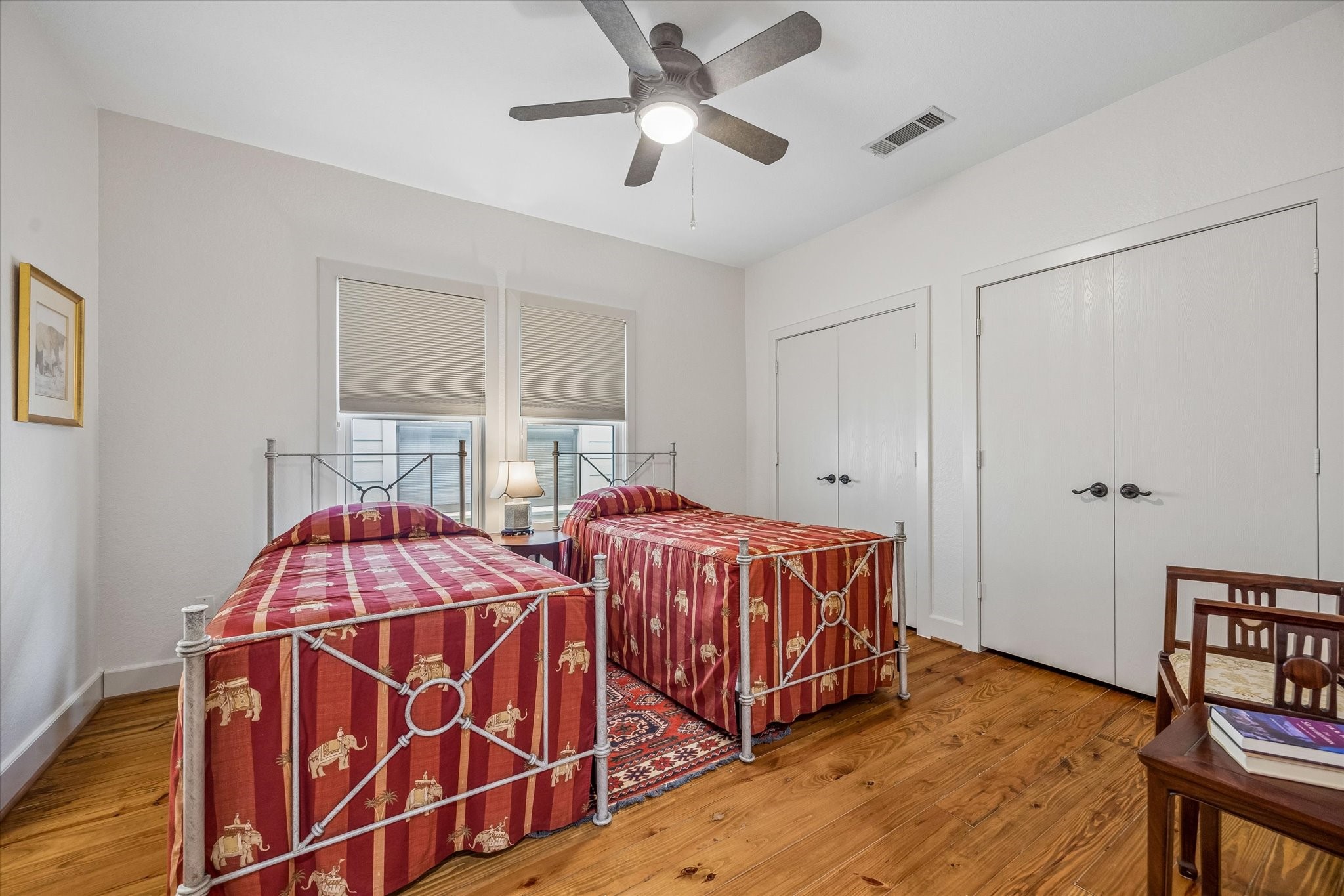 706 East 12th Street Houston, TX 77008 - Photo 25 of 34 a spacious bedroom with two beds and a chandelier