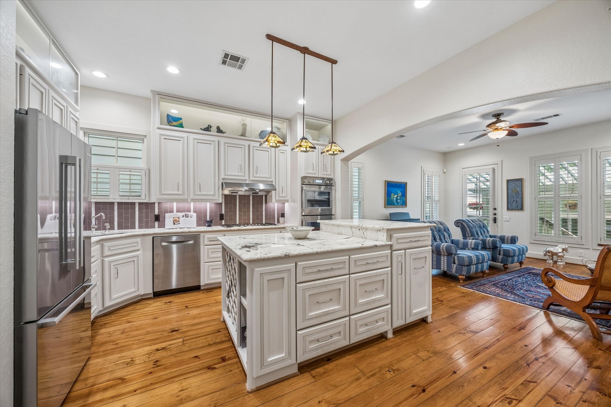 706 East 12th Street Houston, TX 77008 - Photo 4 of 34 a kitchen with kitchen island granite countertop a sink cabinets and wooden floor