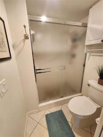 a bathroom with a toilet and a shower