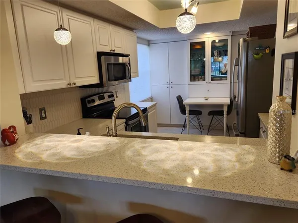 a kitchen with stainless steel appliances granite countertop a sink and a stove
