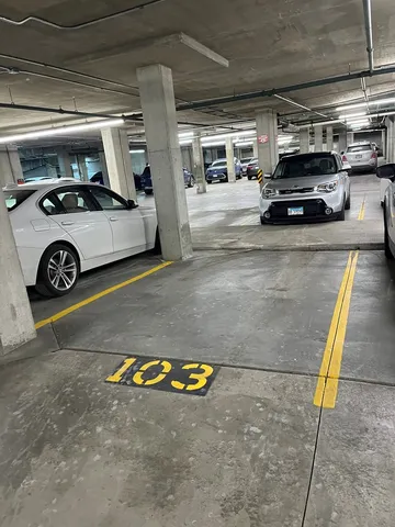 a view of parking garage with cars parked