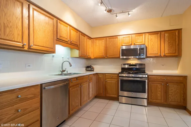 a kitchen with stainless steel appliances granite countertop a sink and cabinets