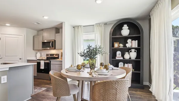 a view of a kitchen area with furniture and wooden floor