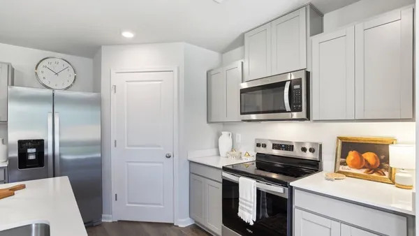 a kitchen with stainless steel appliances a stove microwave and refrigerator
