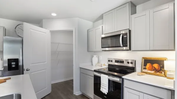 a kitchen with stainless steel appliances a stove microwave and sink
