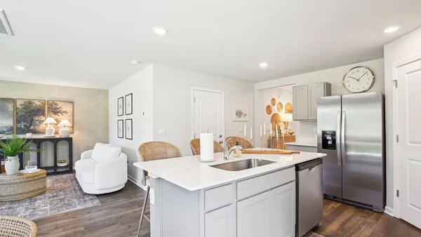a kitchen with granite countertop a sink cabinets and stainless steel appliances