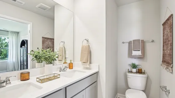 a bathroom with a sink toilet and mirror