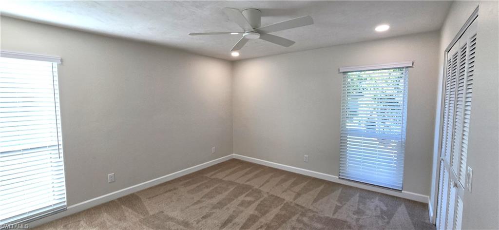 115 Georgetown Boulevard, Unit 115 Naples, FL 34112 - Photo 16 of 32 an empty room with a window and a fan