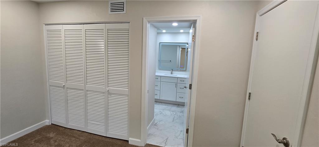 115 Georgetown Boulevard, Unit 115 Naples, FL 34112 - Photo 22 of 32 an empty room with windows