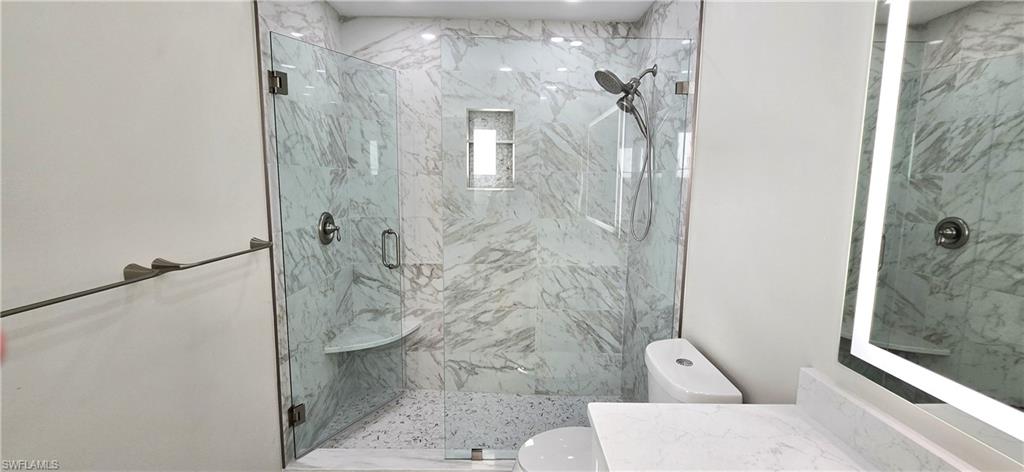115 Georgetown Boulevard, Unit 115 Naples, FL 34112 - Photo 23 of 32 a bathroom with a shower and toilet