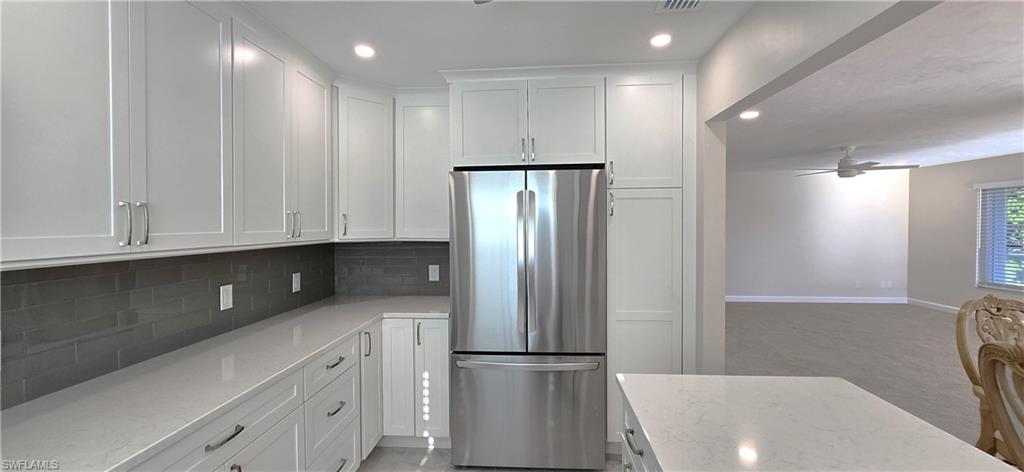 115 Georgetown Boulevard, Unit 115 Naples, FL 34112 - Photo 10 of 32 a kitchen with stainless steel appliances granite countertop a refrigerator and a sink